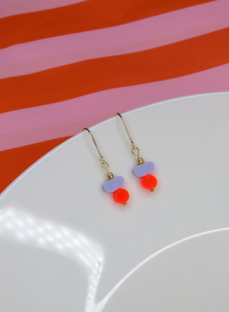 Ohrhänger mit lila Acrylscheibe und neonoranger Acrylperle an goldfarbenem Haken